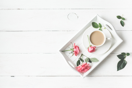 Morning. Vintage. Cup of coffee and rose flowers. Flat lay, top viewの写真素材