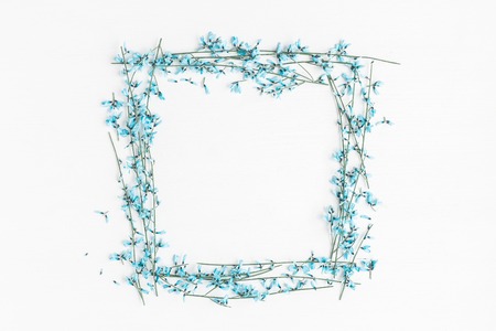 Flowers composition. Frame made of blue flowers on white background. Easter, spring concept. Flat lay, top view, copy spaceの写真素材