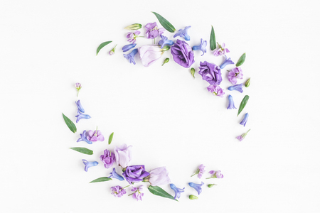 Flowers composition. Wreath made of various colorful flowers on white background. Flat lay, top viewの写真素材