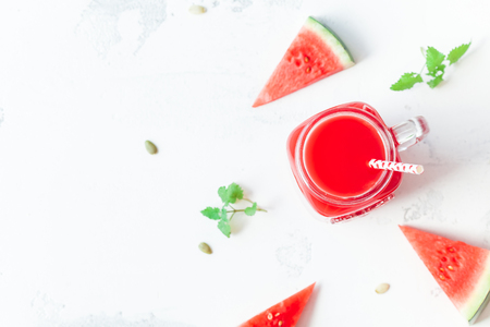 Watermelon juice and watermelon slices on white background. Summer concept. Top view, flat lay, close upの写真素材