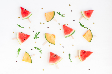 Watermelon popsicle and melon popsicle on white background. Top view, flat layの写真素材