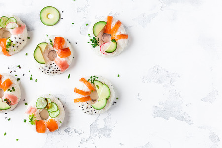 Sushi donuts set on white background. Sushi trend. Creative food. Flat lay, top viewの写真素材