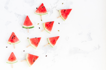 Watermelon popsicle. Sliced watermelon on white background. Flat lay, top viewの写真素材