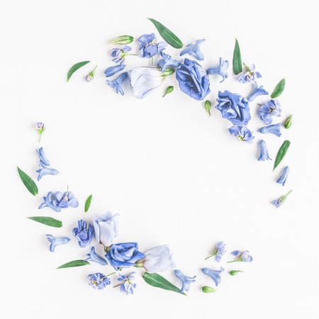 Flowers composition. Wreath made of blue flowers on white background. Flat lay, top viewの写真素材