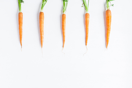 Carrots. Fresh colorful carrots on white background. Flat lay, top view