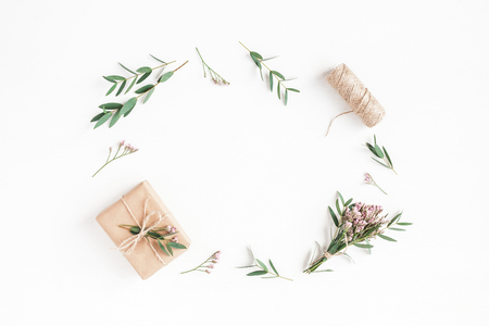 Flowers composition. Gifts, pink flowers and eucalyptus branches on white background. Flat lay, top view