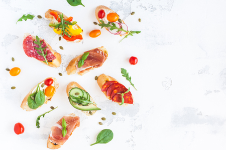 Traditional spanish tapas on white table. Brushetta set. Flat lay, top view, copy spaceの写真素材