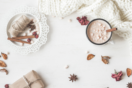 Autumn. Hot chocolate, knitted blanket, gift, dried flowers and leaves. Flat lay, top viewの写真素材