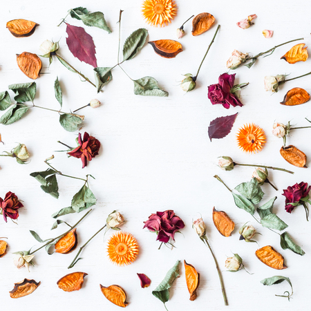 frame made of dried flowers and autumn leaves, top view, flat lay