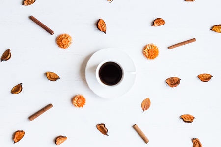 cup of coffee with autumn leaves, cinnamon sticks, top view, flat layの写真素材