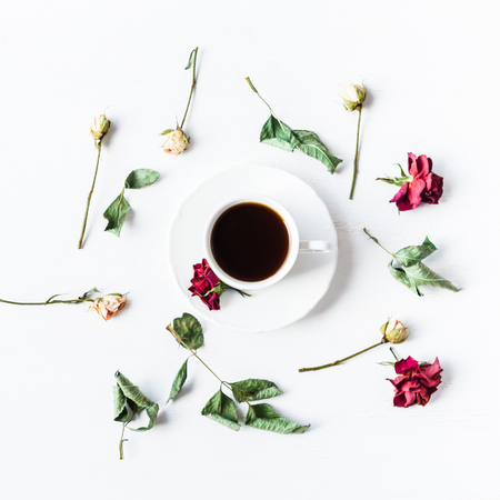 cup of coffee with dried rose flowers, square, top view, flat layの写真素材