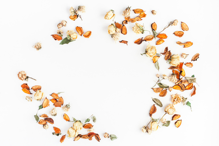 Autumn composition. Frame made of autumn dried flowers and leaves on white background. Flat lay, top view, copy space.の写真素材
