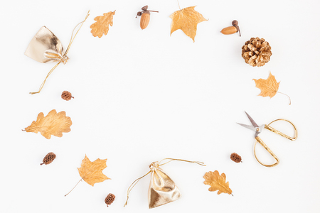 Autumn composition. Gifts, autumn golden leaves, pine cones, accessories on white background. Flat lay, top view, copy spaceの写真素材