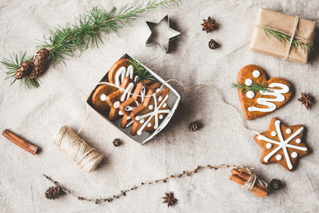 Christmas composition. Gift, larch branches, cinnamon sticks, anise star, christmas cookies. Top view, flat layの写真素材
