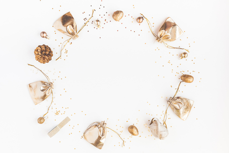 Christmas composition. Christmas gifts, pine cones, golden decorations on white background. Flat lay, top view, copy spaceの写真素材