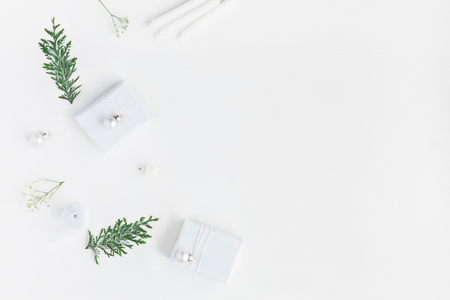 Christmas composition. Christmas gifts, pine cones, gypsophila flowers, thuya branches on white background. Flat lay, top view, copy spaceの写真素材