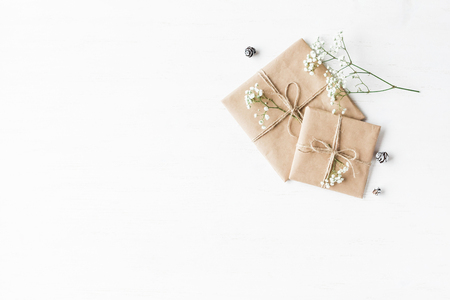 Christmas composition. Christmas gift, pine cones and gypsophila flowers. Top view, flat layの写真素材