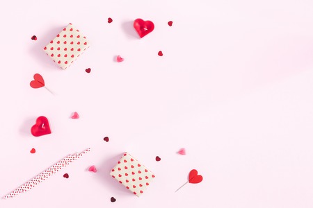 Valentine's Day. Frame made of gifts, candles, confetti on pink background. Valentines day background. Flat lay, top view, copy spaceの写真素材