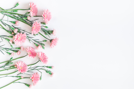 Flowers composition. Frame made of pink gerbera flowers on white background. Flat lay, top view, copy spaceの写真素材