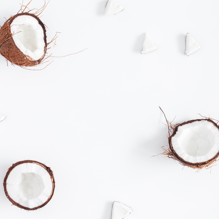 Coconut background. Fresh coconuts on white background. Flat lay, top view, copy space, squareの写真素材