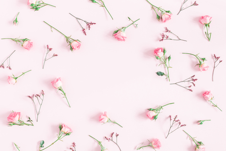 Flowers composition. Frame made of pink rose flowers on pink background. Flat lay, top view, copy space, squareの写真素材