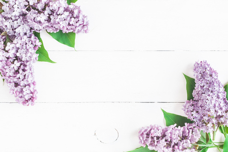Flowers composition. Spring lilac flowers on white wooden background. Flat lay, top view, copy spaceの写真素材