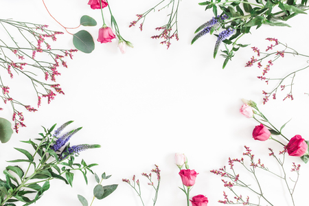 Flowers composition. Frame made of various colorful flowers on white background. Flat lay, top view, copy spaceの写真素材