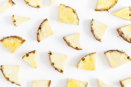 Pineapples on white background. Pattern made of sliced pineapples. Flat lay, top viewの写真素材
