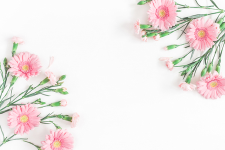 Flowers composition. Frame made of pink flowers on white background. Flat lay, top view, copy spaceの写真素材