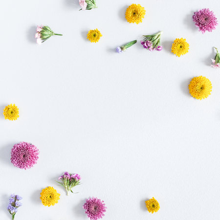 Flowers composition. Frame made of colorful flowers on gray background. Flat lay, top view, square, copy spaceの写真素材