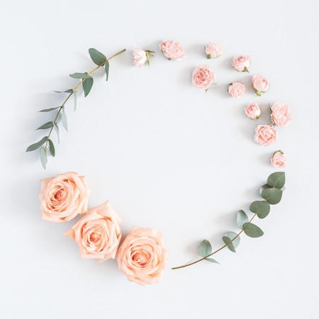 Flowers composition. Wreath made of rose flowers, eucalyptus branches on pastel gray background. Flat lay, top view, copy space, squareの写真素材