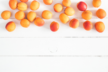 Apricots on white wooden background. Flat lay, top view, copy spaceの写真素材
