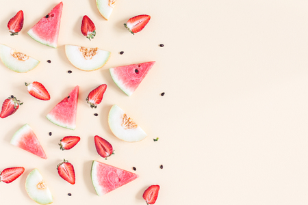 Fruit background. Watermelon, melon, strawberry on pastel yellow background. Summer concept. Flat lay, top view, copy spaceの写真素材