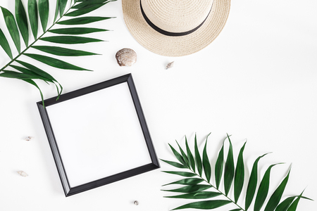 Summer composition. Tropical palm leaves, hat, photo frame, coconut on white background. Summer concept. Flat lay, top view, copy spaceの写真素材