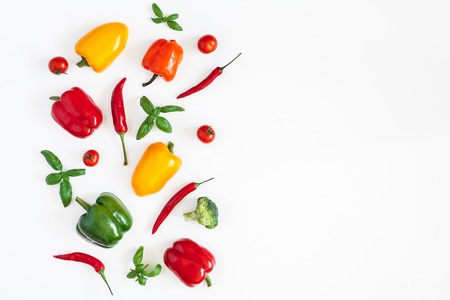 Vegetables on white background. Frame made of fresh vegetables. Tomatoes, peppers, cabbage, green leaves. Flat lay, top view, copy spaceの写真素材