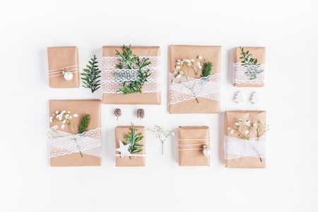 Christmas composition. Christmas gifts, pine cones, gypsophila flowers, thuja branches on white background. Flat lay, top viewの写真素材
