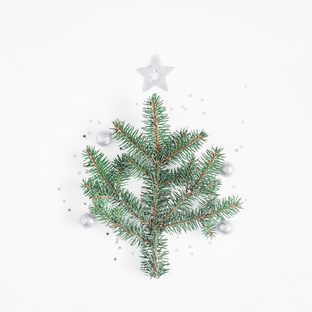 Christmas tree made of fir branches and silver decorations. Christmas, winter, new year concept. Flat lay, top view, squareの写真素材