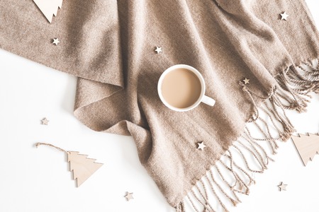 Christmas composition. Cup of coffee, plaid, wooden toys on white background. Christmas, winter, new...