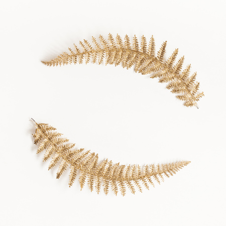 Christmas composition. Wreath made of golden decorations on white background. Christmas, winter, new year concept. Flat lay, top view, copy space, squareの写真素材