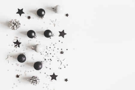 Christmas composition. Christmas black and silver decorations on pastel gray background. Flat lay, top view, copy spaceの写真素材