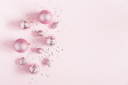 Christmas composition. Christmas pink decorations on pastel pink background. Flat lay, top view, copy spaceの写真素材