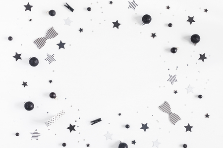 Christmas composition. Christmas black and silver decorations on white background. Flat lay, top view, copy spaceの写真素材