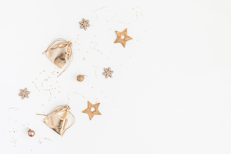 Christmas composition. Christmas gifts, pine cones, golden decorations on white background. Flat lay, top view, copy spaceの写真素材