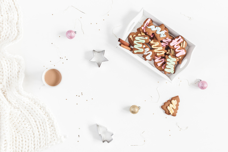 Christmas composition. Christmas gingerbread cookies, cup of coffee, knitted blanket on white background. Flat lay, top viewの写真素材