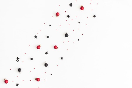 Christmas composition. Christmas black and red decorations on white background. Flat lay, top view, copy spaceの写真素材