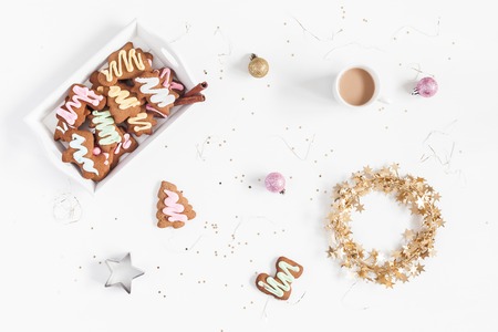 Christmas composition. Christmas gingerbread cookies, cup of coffee on white background. Flat lay, top viewの写真素材
