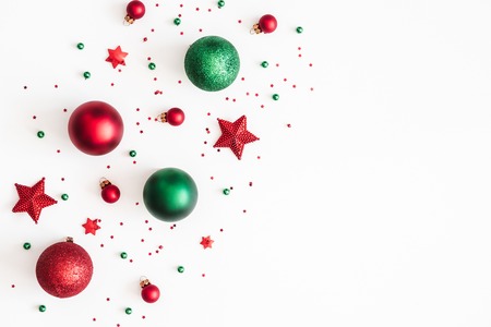 Christmas composition. Christmas red and green decorations on white background. Flat lay, top view, copy spaceの写真素材