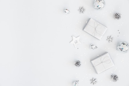Christmas composition. Christmas gifts, silver decorations on pastel gray background. Flat lay, top view, copy spaceの写真素材