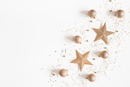Christmas composition. Christmas golden decorations on white background. Flat lay, top view, copy spaceの写真素材