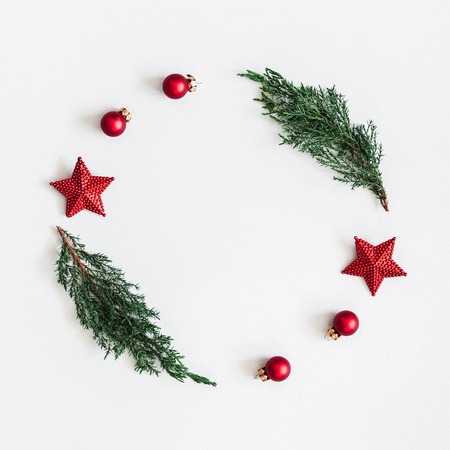 Christmas composition. Wreath made of coniferous tree branches, balls, pine cones on pastel gray background. Christmas, winter, new year concept. Flat lay, top view, square, copy spaceの写真素材